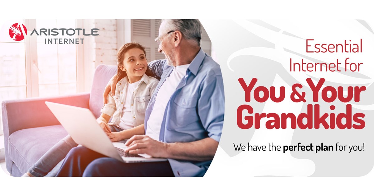 Smiling grandfather and granddaughter using laptop computer and Aristotle High Speed Internet