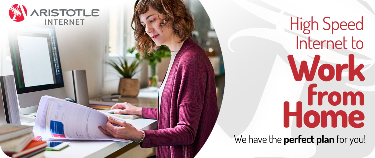 Woman works from home at a desktop computer with Aristotle High Speed Internet